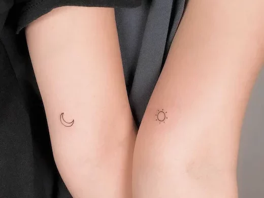 Tatuajes sol y luna en zona de codo interior